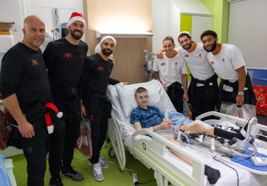 LFC players and manager pose for a picture with an Alder Hey patient