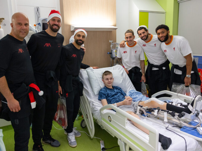 LFC players and manager pose for a picture with an Alder Hey patient