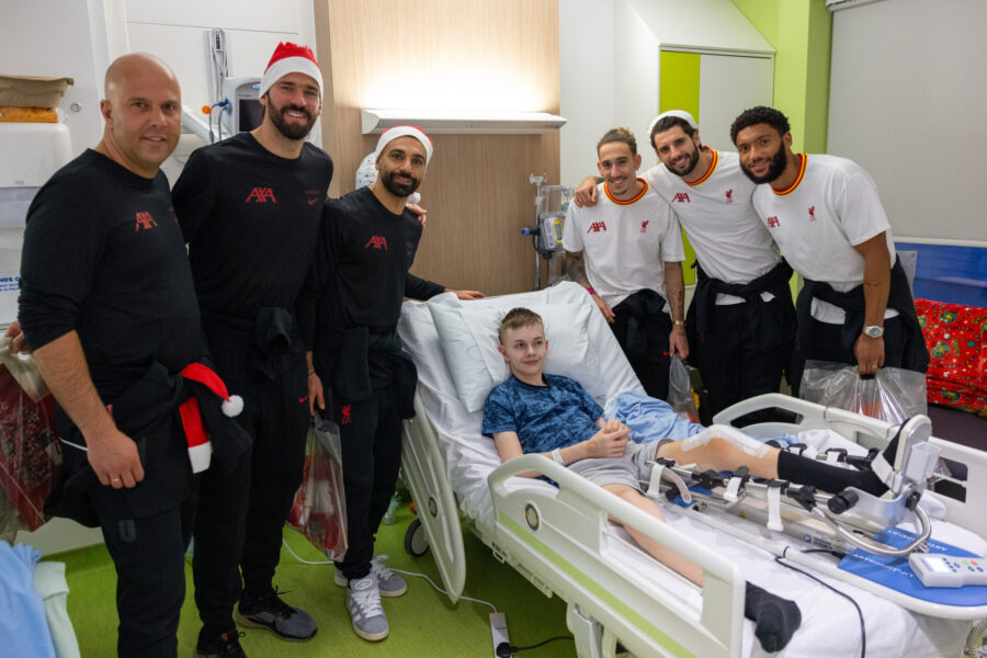 LFC players and manager pose for a picture with an Alder Hey patient