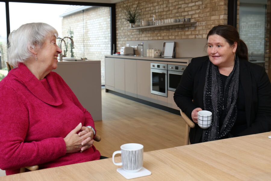 Two people talking over a cup of tea in the Alder Centre