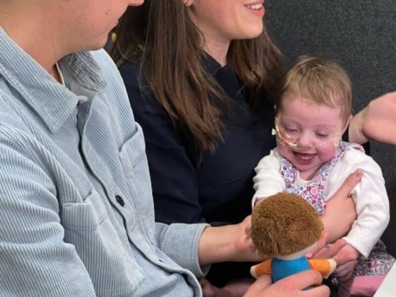 Parents post with their baby in Alder Hey's Innovation Hub